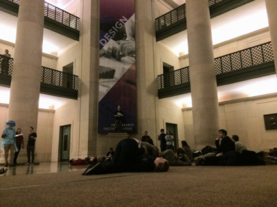 Another photo of Lobby 7, but will other people haphazardly laying all over the floor. Someone dressed as a jellyfish is holding a clipboard.